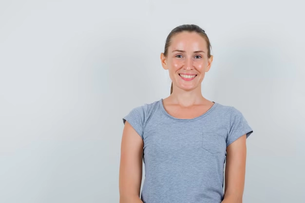 GlycoHarmony consumer portrait of a healthy middle-aged woman in a grey t-shirt smiling, showcasing fit metabolic health.